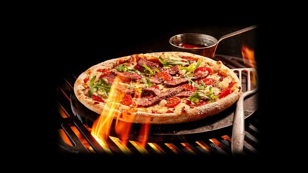 Flame-grilled pizza over open flame