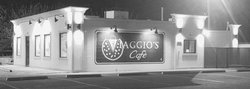 Viaggio's Café storefront at night, corner of NE 23rd St and Spencer Rd